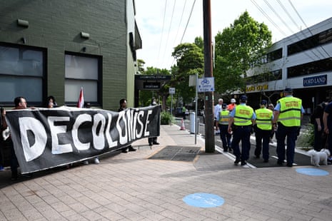 Protesters holding sign saying "decolonise"