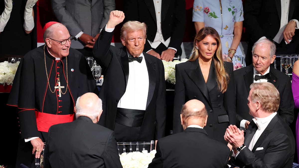 New York Archbishop Cardinal Timothy M. Dolan, Republican presidential nominee and former U.S. President Donald Trump and Melania Trump attend the 79th annual Alfred E. Smith Memorial Foundation Dinner in New York City, U.S. October 17, 2024. REUTERS/Brendan McDermid