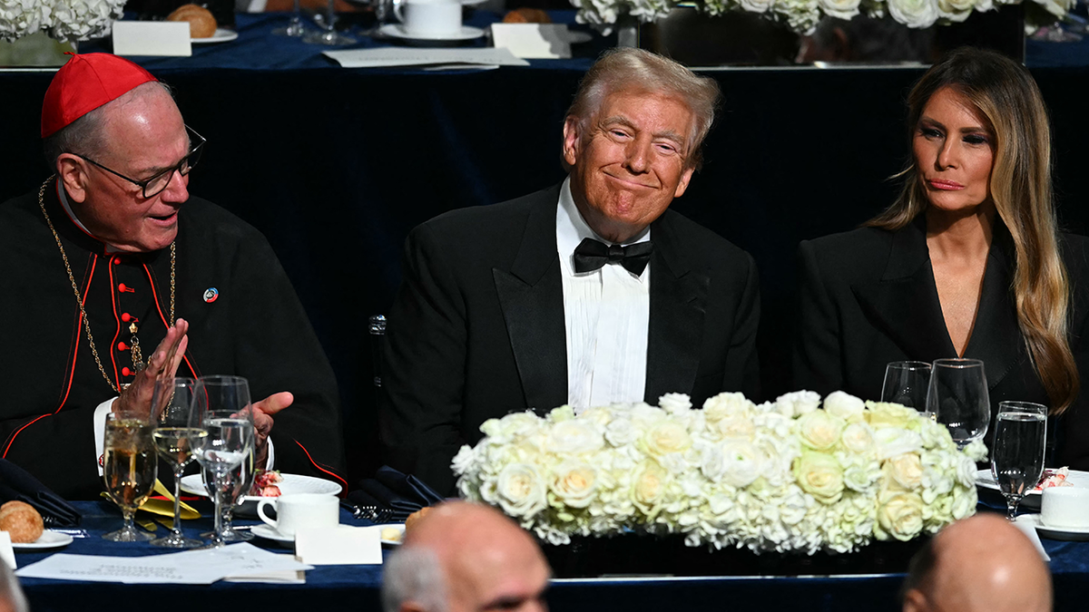  Former US President and Republican presidential candidate Donald Trump with his wife Melania Trump and Archbishop of New York Timothy M. Dolan (L) attend the 79th Annual Alfred E. Smith Memorial Foundation Dinner at the Hilton Midtown in New York, October 17, 2024. (Photo by Timothy A. CLARY / AFP) (Photo by TIMOTHY A. CLARY/AFP via Getty Images)