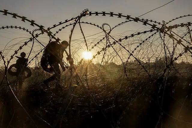 Soldiers training by barbed wire