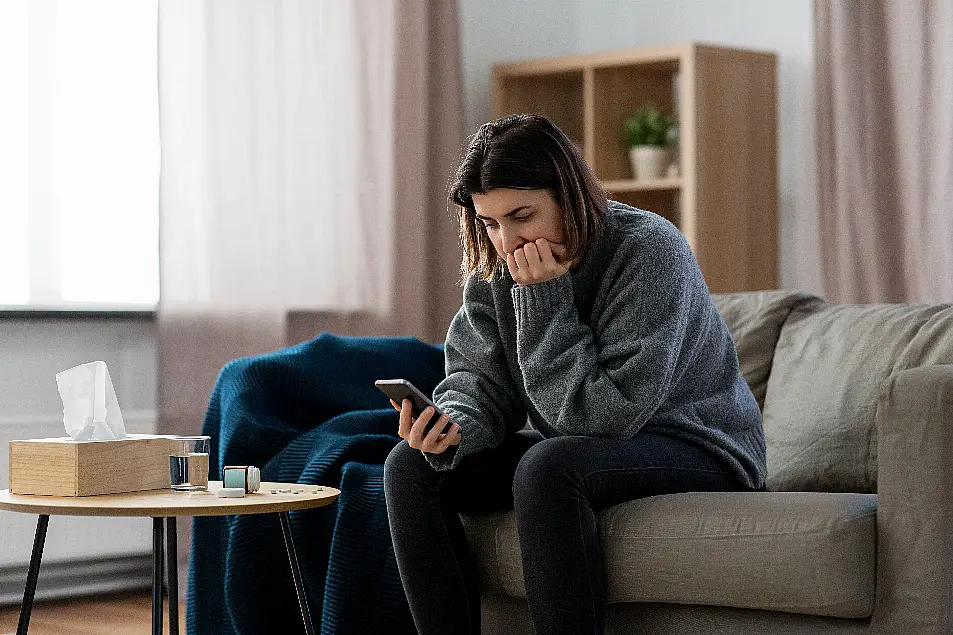 Stressed woman looking at her phone