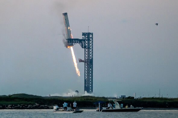 A SpaceX Heavy Booster is grabbed by 'chopsticks' at the launch pad in Texas in October