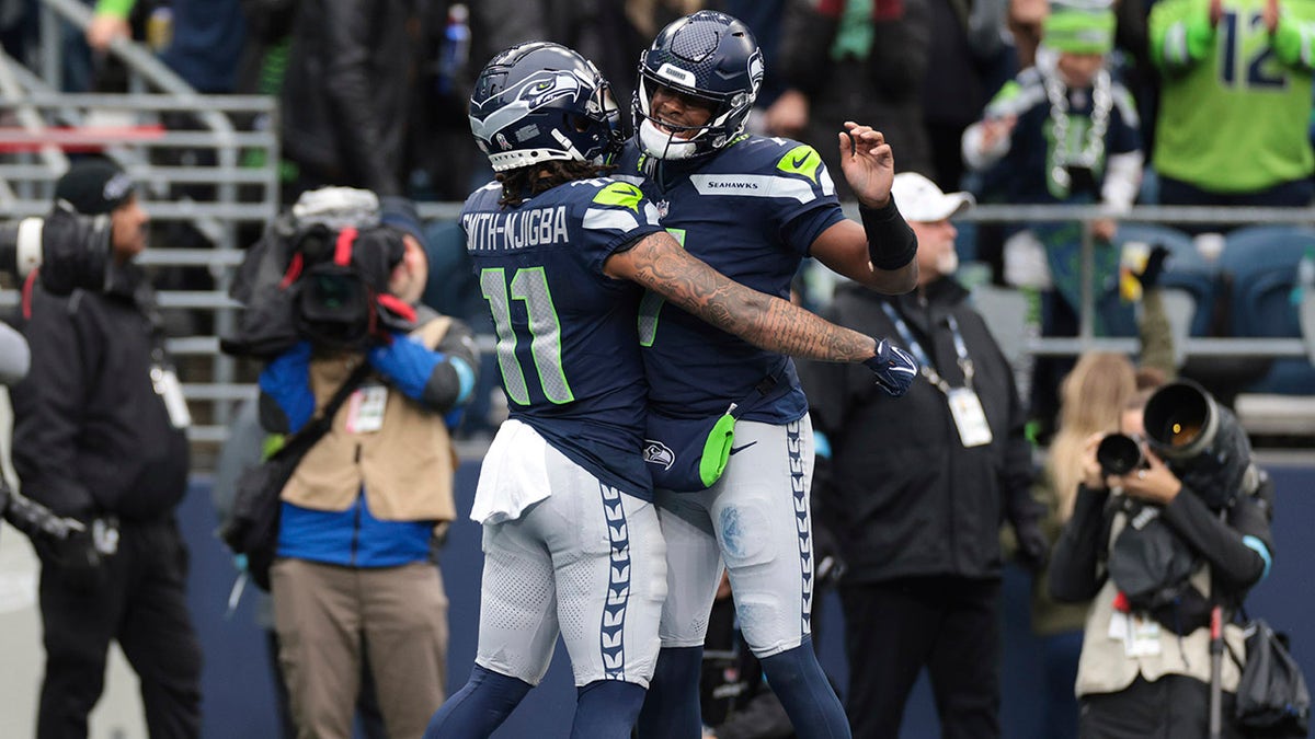 Geno Smith and Jaxon Smith-Njigba celebrate