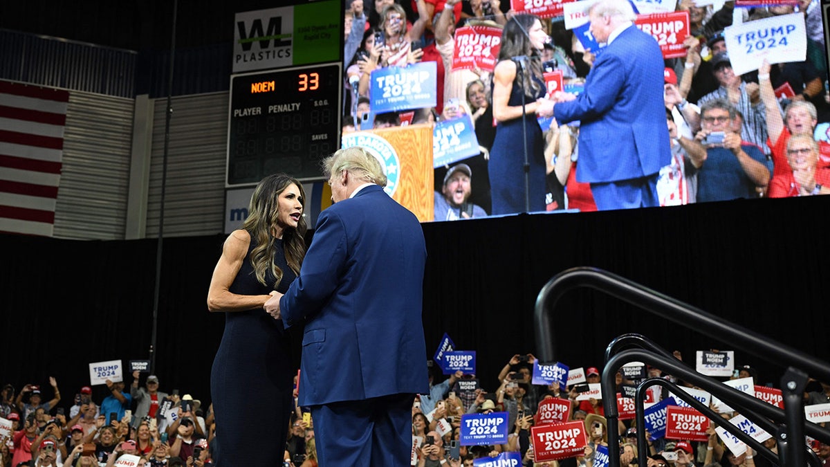 Noem shakes Trump's hand on stage